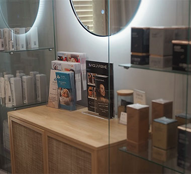 Medical spa skincare products and treatment brochures displayed on a shelf at Pure Esthetics
