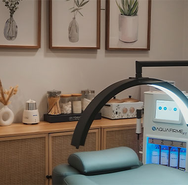 AquaFirme facial treatment machine in a modern medical spa treatment room.